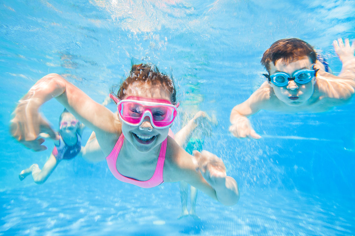 Children wearing swim goggles in a pool