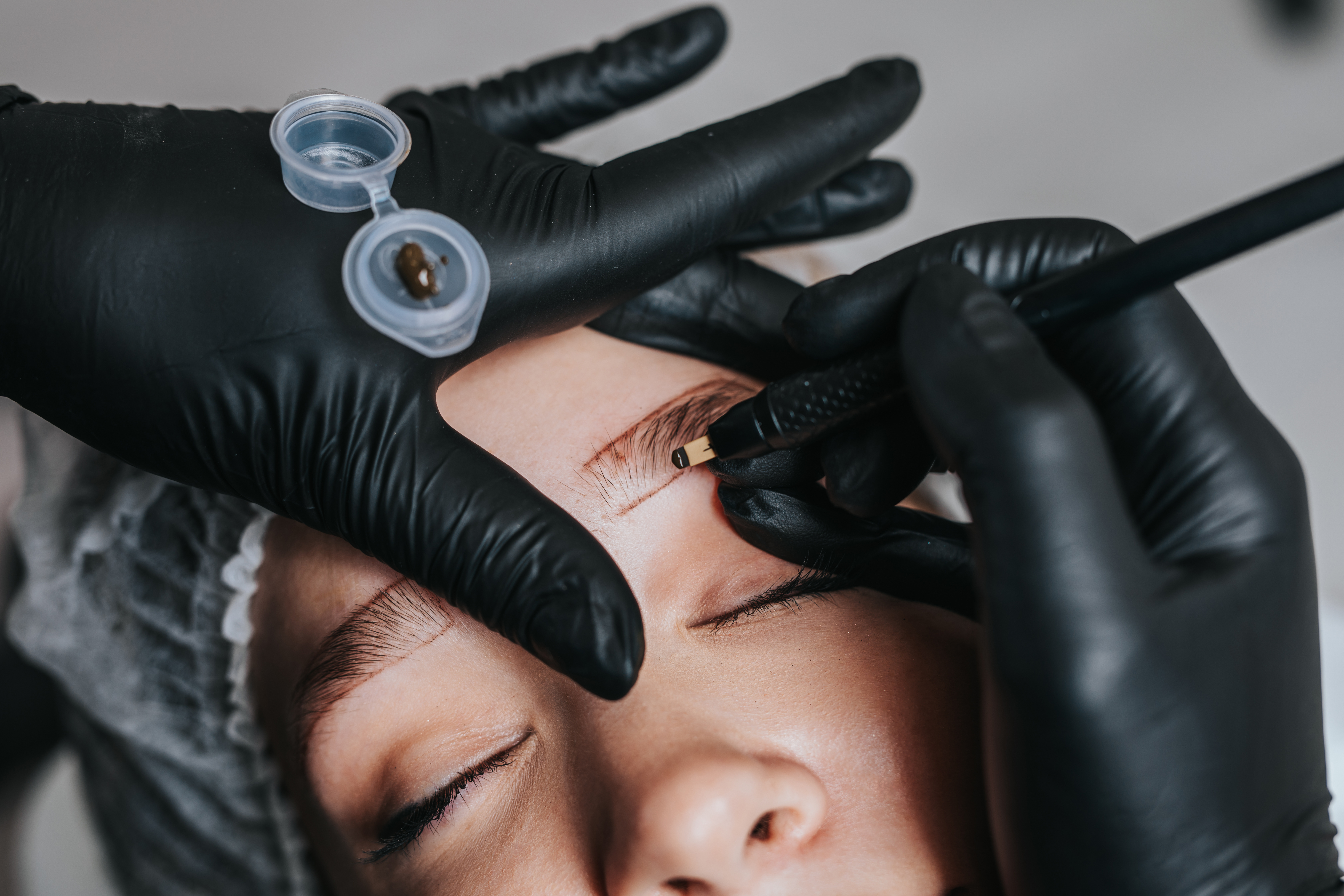 A woman receiving permanent makeup procedure.