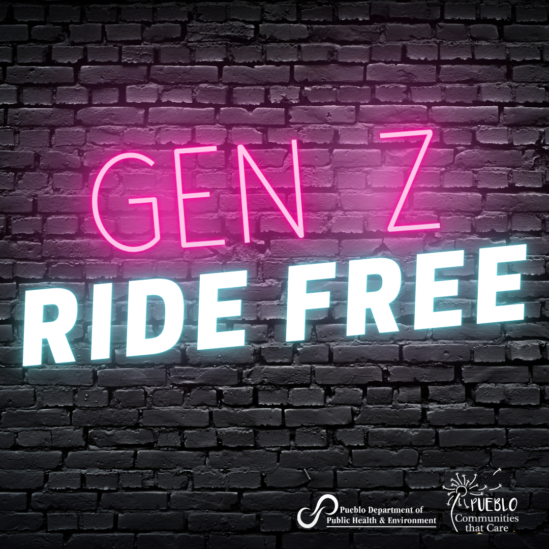 A neon sign reading 'Gen Z Ride Free' on a brick wall