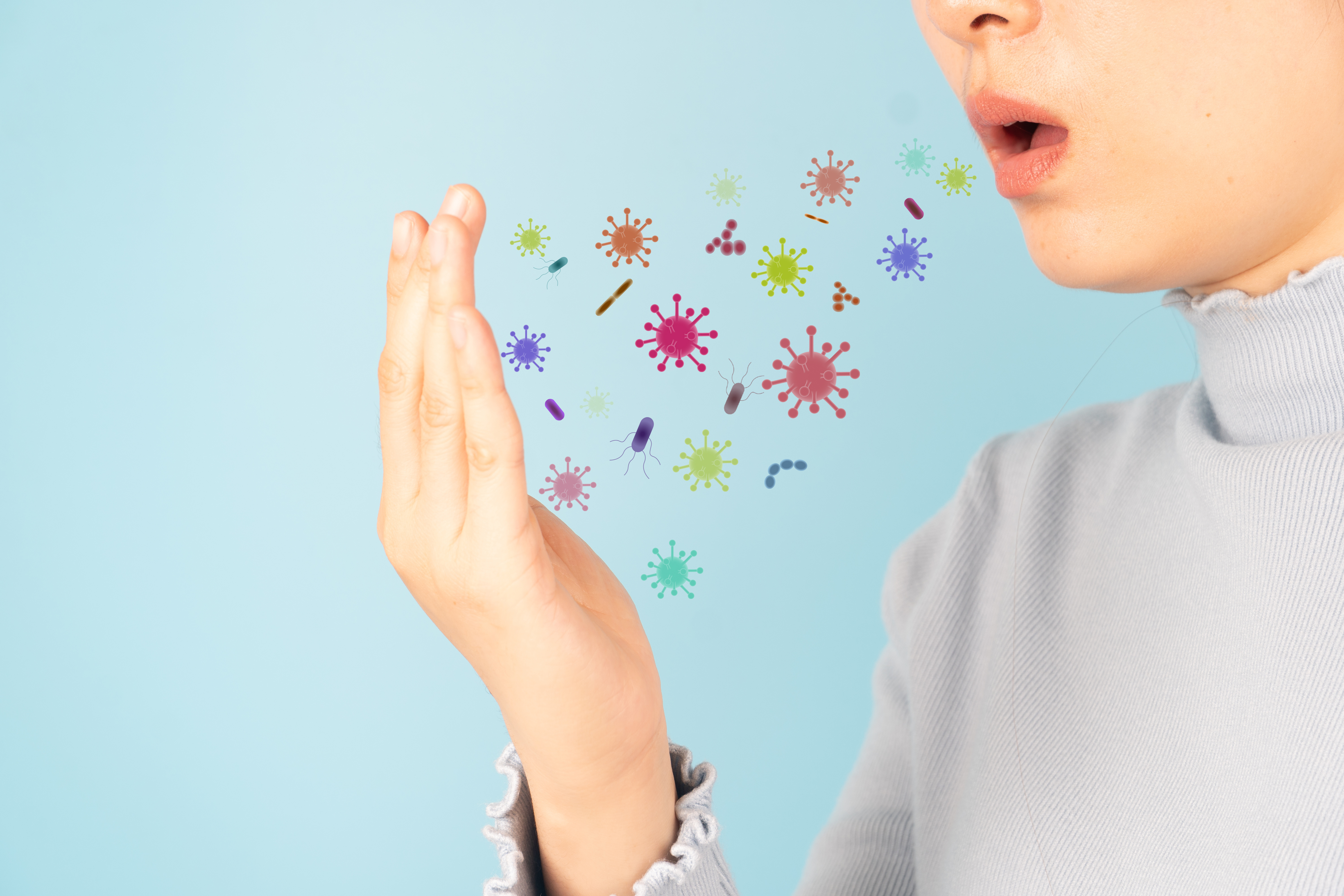 Person coughing; droplets spreading through the air