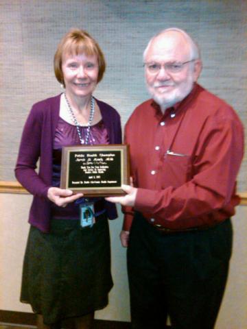 Dr. Jarvis Ryals receiving Public Health Champion plaque 